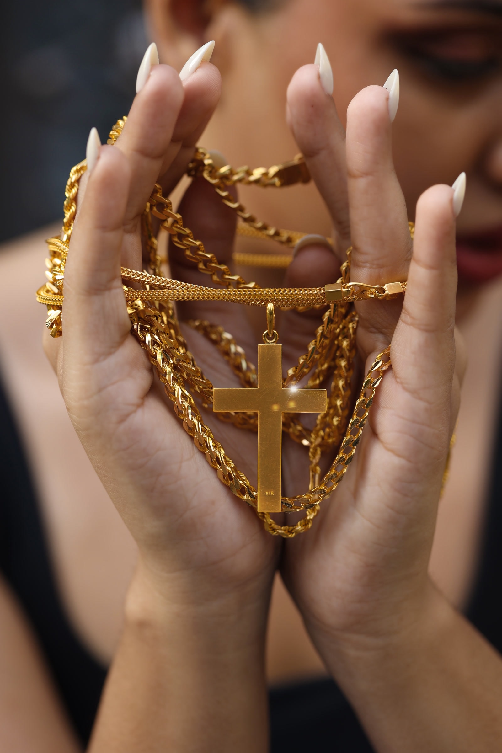 Gold chains and a gold cross pendant by JK Gold House